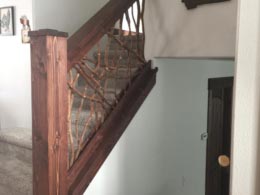 Interior stair handrail in Kalispell, MT, featuring a Montana branch banister on the staircase, with multiple views showcasing the branch design and a short section of stair railing.