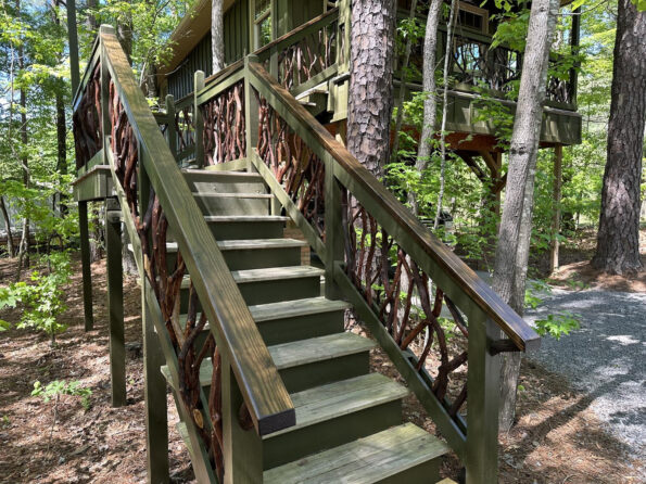 Green stair handrails made from mountain laurel branches in Asheville, NC, showcasing natural beauty and craftsmanship.