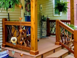 Homey front porch in Clayton, NJ, featuring dark stained branch rails and small handrail sections on the side view.