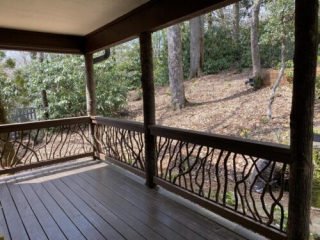 Porch in Blowing Rock, NC featuring a newly installed Mountain Laurel Handrail with natural branch design.