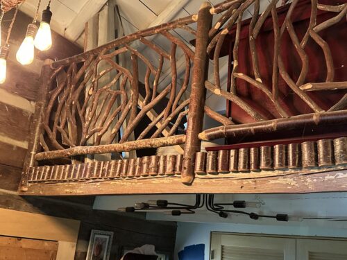 Interior handrails in Tiger, GA featuring rustic mountain laurel branch railings paired with wild cherry wood posts, showcasing handcrafted natural wood artistry.
