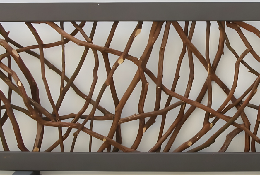 Close-up of a decorative twig panel featuring a crisscross pattern, enclosed by dark metal frames on a light background.