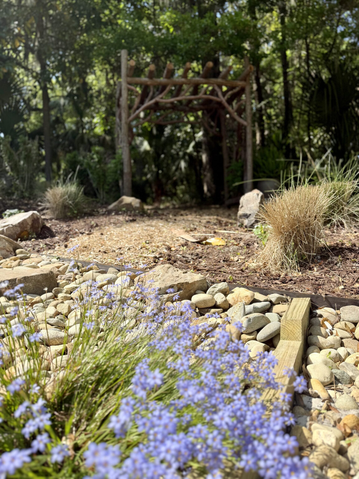 Flowers with a Rustic arbor in the background