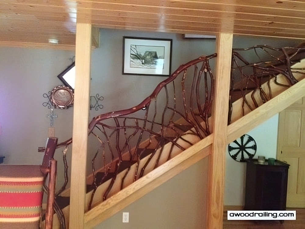 Rustic mountain laurel log handrail stair railing stained dark red, showcasing natural beauty and craftsmanship for unique deck railing design.