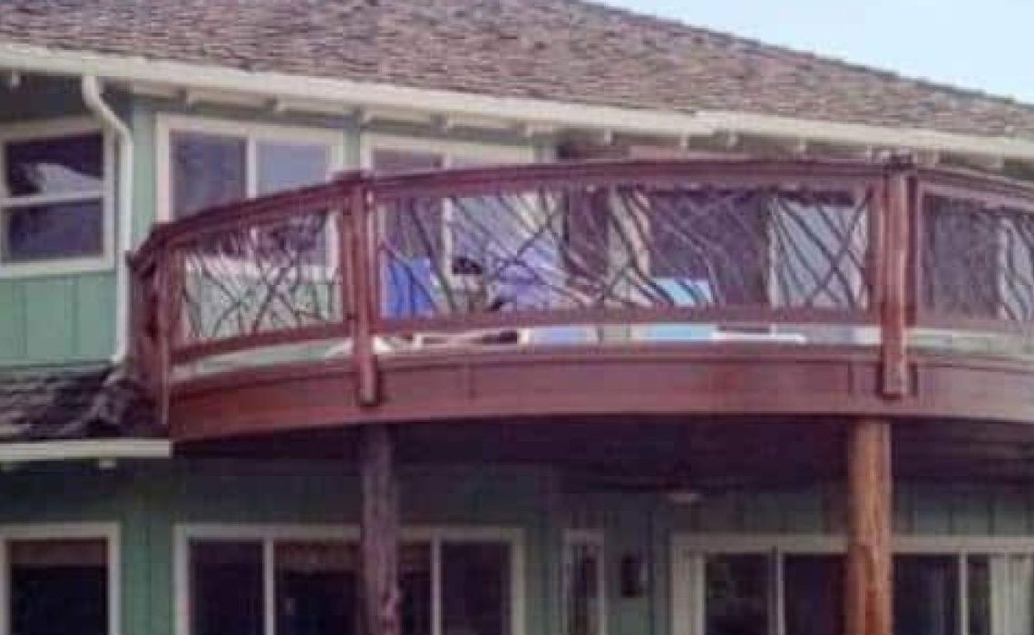 A product photo showing a full view of a curved handrail on a back porch, forming a half circle.