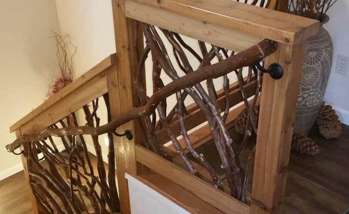 A branch banister seamlessly attached to Mountain Laurel handrails on a staircase, showcasing natural wood textures.