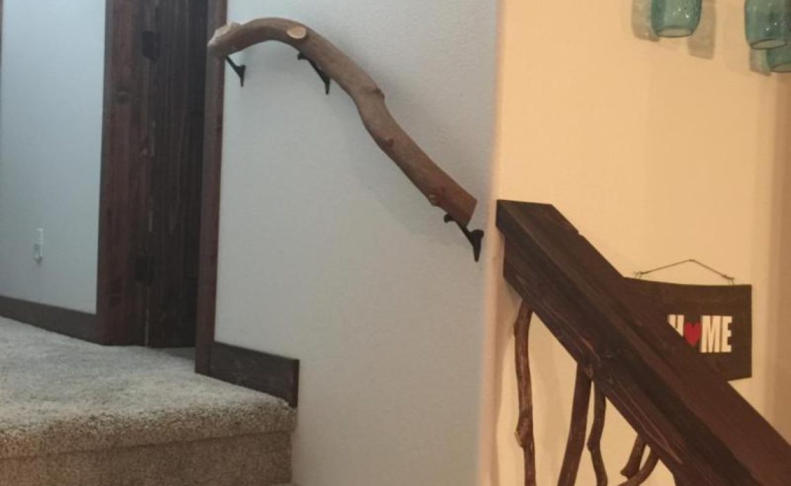 A branch banister elegantly leading to Mountain Laurel stair handrails, showcasing a seamless transition between natural designs.