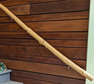 Polished Locust Branch Banister Handrail Handcrafted polished locust branch banister handrail with bark removed, showcasing smooth natural grain and warm wood tones.