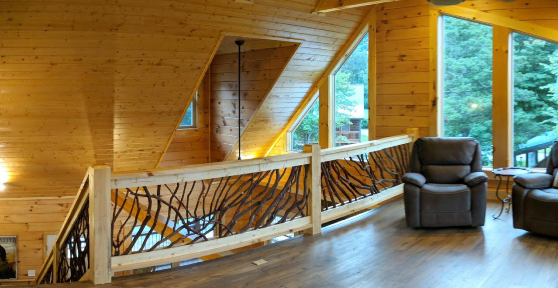 A stylish balcony railing in a top floor lounge area featuring comfortable recliner chairs, overlooking the scenic views of Maggie Valley, NC.