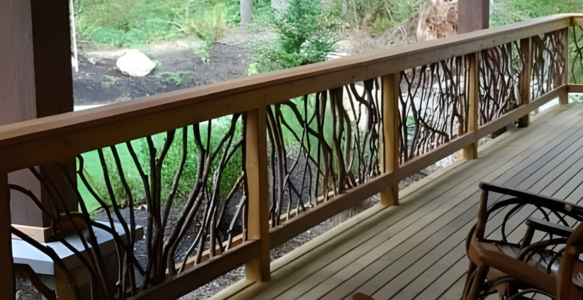 Wooden deck with handcrafted woven branch railing, wooden chairs, and a lush green forest view in the background.