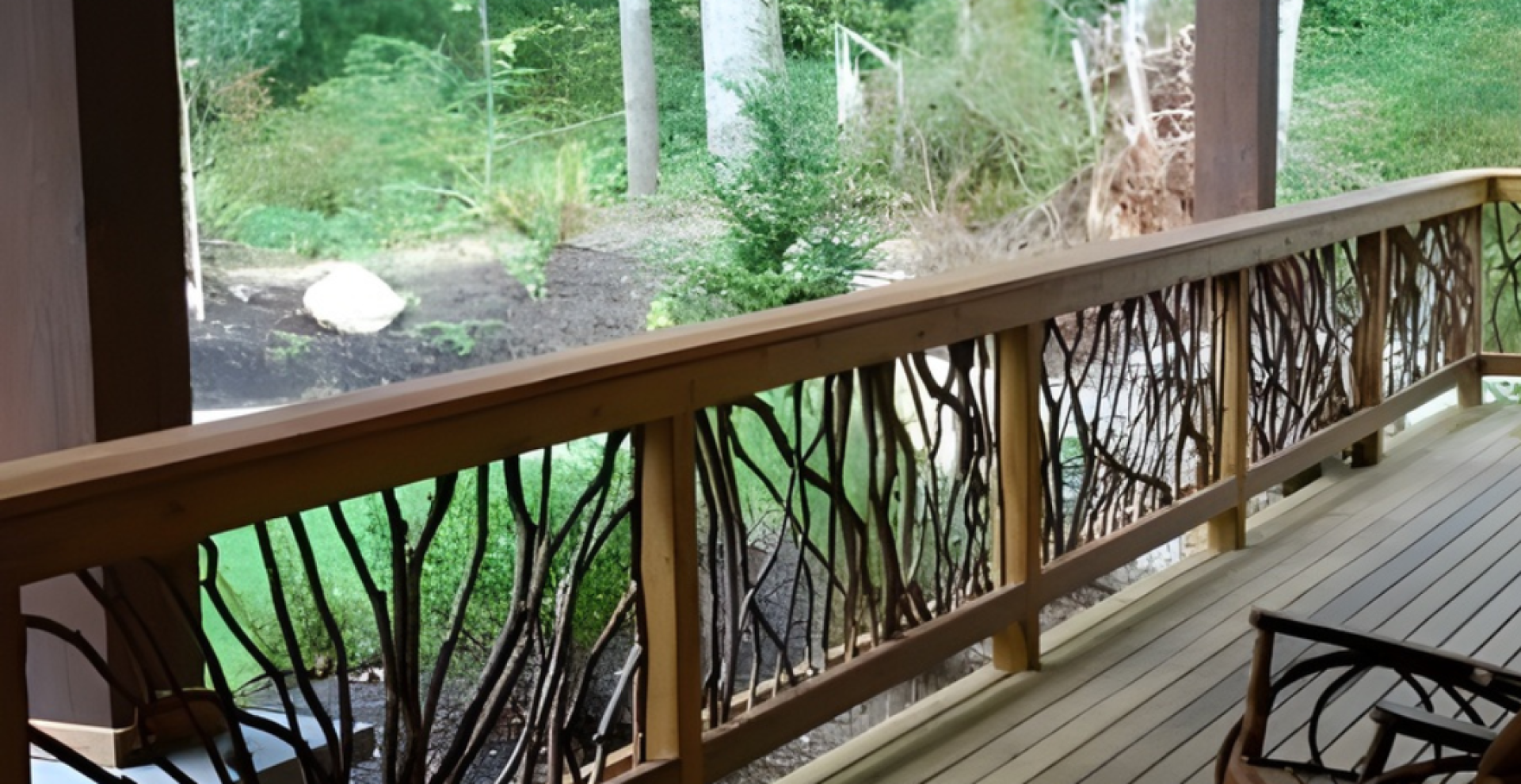 Wooden deck with handcrafted woven branch railing, wooden chairs, and a lush green forest view in the background.