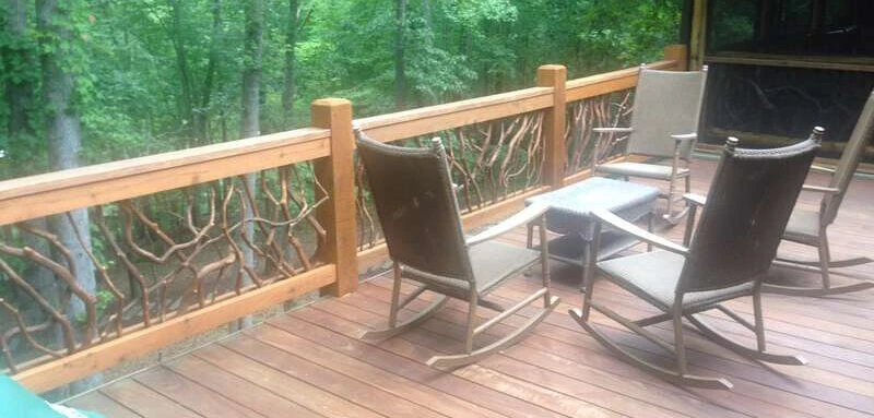 A beautifully stained deck adorned with comfortable rocking chairs, creating a cozy outdoor retreat.