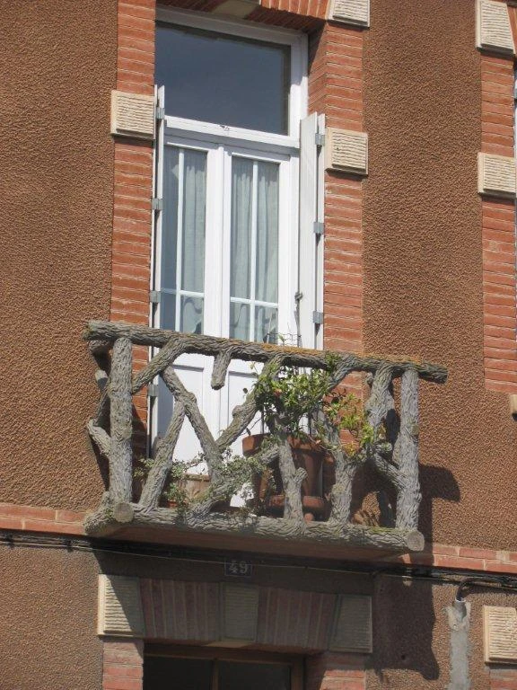 French Camino rustic log balcony railing showcasing natural wood craftsmanship