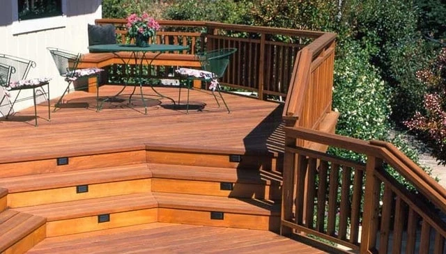 A distinctive deck railing design with a smooth 2x6 top rail and sleek 2x4 balusters, showcasing timeless elegance and modern craftsmanship.