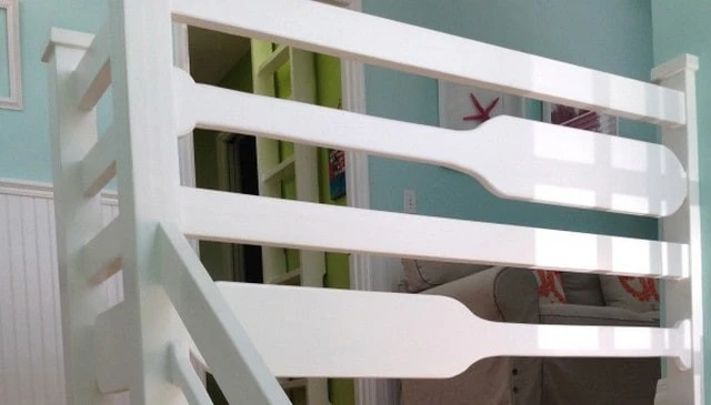 A creative handrail design featuring horizontal paddles that create contrived proportions for a unique and eye-catching look