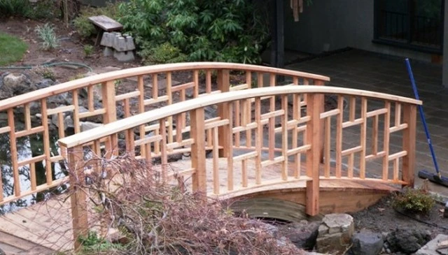 A Zen-inspired bridge railing showcasing a blend of Craftsman style and East Asian design, exemplifying carpentry charm in outdoor aesthetics.