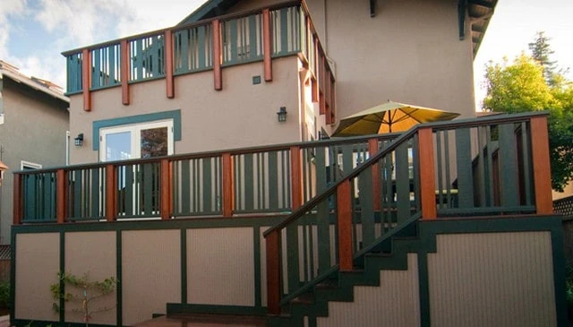 A two-width two-color railing design showcasing 1x6 boards with double 2x2 balusters, exemplifying a stylish outdoor look in deck railing designs.