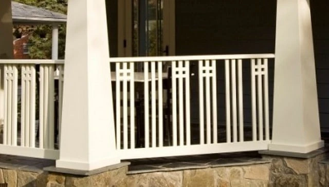A deck railing design blending American Craftsman and Art Deco styles, showcasing dark tones with light vertical railing and obelisk style posts, exemplifying balanced outdoor aesthetics.