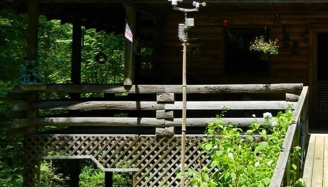 A budget-friendly rustic deck railing showcasing horizontal 6x6 lumber with block spacing, exemplifying a big timber aesthetic in outdoor design.