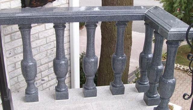 Slender black marble turned railings showcasing a shiny adornment for the front porch, exemplifying sophisticated outdoor railing designs.