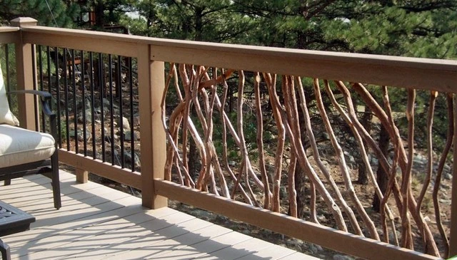 Mixed metal and branch railing sections on a deck showcasing a composite lumber framework and composite decking, exemplifying modern deck railing designs.