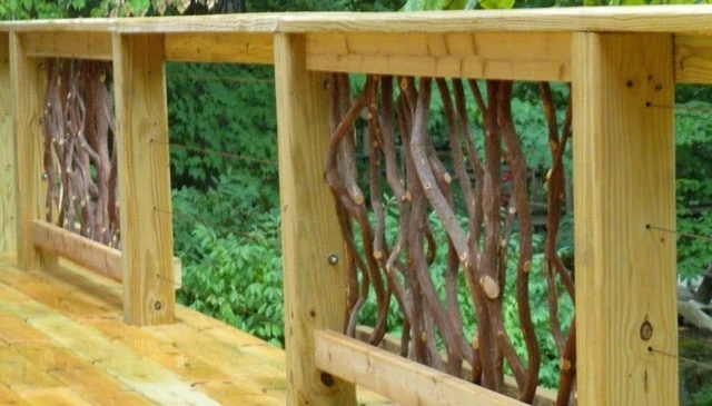 A mountain laurel handrail combined with horizontal cable railing, blending natural branches with unobstructed views, exemplifying unique deck railing designs.