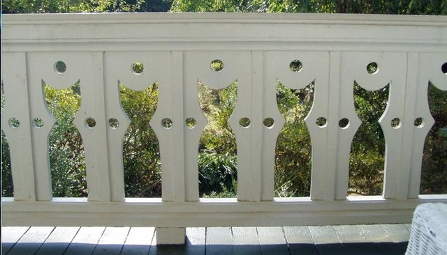 Cat-inspired sawn balusters showcasing unique cutouts of playful cats surrounded by circles, exemplifying whimsical deck railing designs for cat lovers.