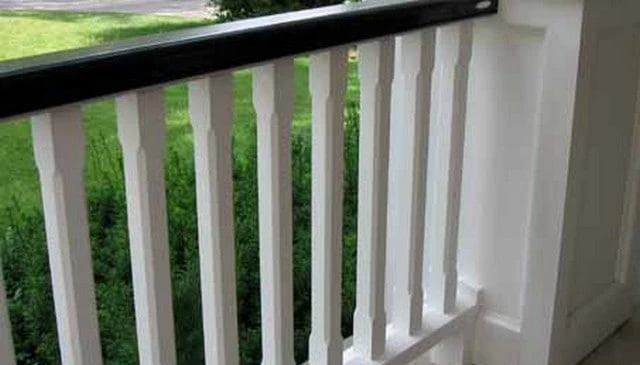 Colonial chamfered and milled spindles showcasing timeless elegance in a pristine white railing system, exemplifying classic outdoor aesthetics.