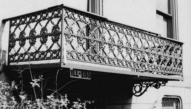 Wrought iron railings showcasing an interlaced circular pattern with central circles and rows of small circles at the top and bottom, exemplifying sophisticated outdoor aesthetics.
