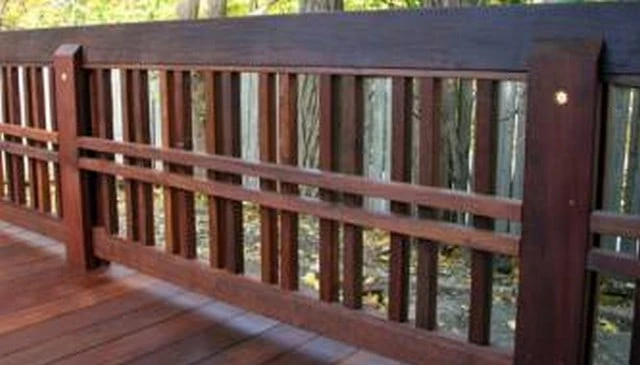A craftsman handrail design showcasing alternately spaced double porch spindles with central horizontal elements and a 2x6 top rail exemplifying traditional outdoor aesthetics.
