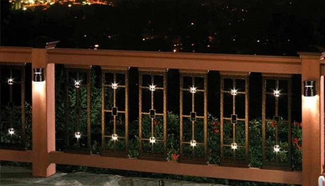 Craftsman style metal panels showcasing square shapes in guardrail openings with integrated lighting and downlights on posts exemplifying modern outdoor design.