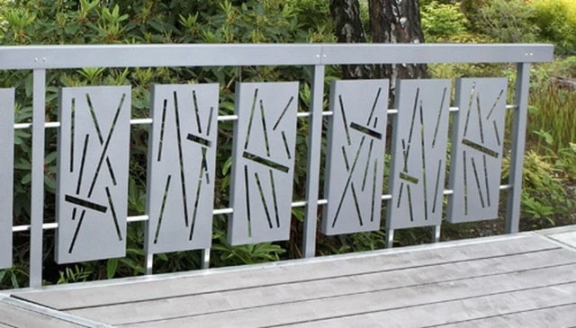 Abstract metal panels showcasing a series of three lines capped with a rectangular profile set against a scenic rhododendron forest background exemplifying contemporary outdoor design.