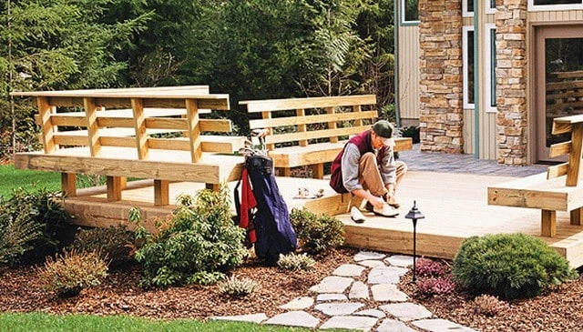 A modern rustic outdoor deck design showcasing triangle geometry with 1x4 lumber over a branch guard rail exemplifying creative deck railing designs.