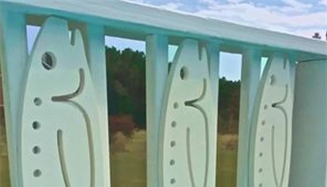 Fish-shaped balusters showcasing an ideal design for anglers and avid fishermen exemplifying creative deck railing designs perfect for outdoor spaces.