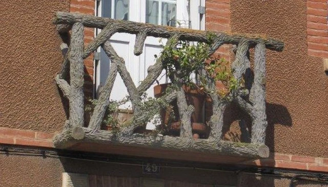 An open log railing balcony captured during a hiking adventure on the French Way of the Camino de Santiago showcasing rustic deck railing designs.