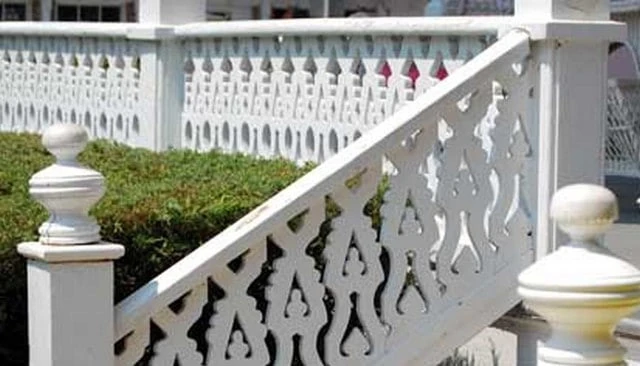 A flame-like front porch railing showcasing sawn balusters with infinite design adaptations exemplifying creative handrail designs.