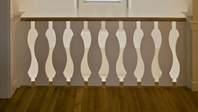 Sawn balusters with a graceful arc, featuring alternating directions that create a stylized goose or swan design, enhancing the aesthetic of outdoor spaces.