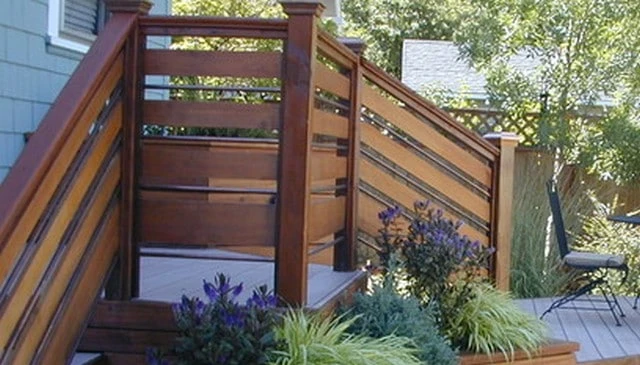 A contemporary porch and patio design showcasing alternating horizontal boards in diminishing sizes, complemented by a metal pipe for eye-catching appeal.