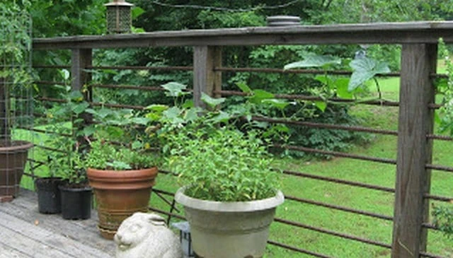 A DIY deck railing design featuring 4x4 pressure treated posts and horizontal 1/2" rebar, creating a sturdy and accessible project for outdoor spaces.