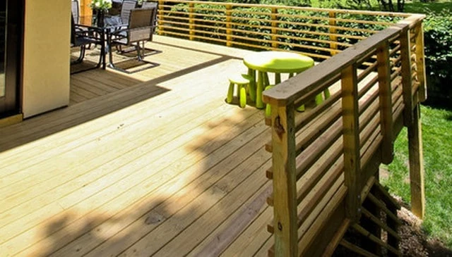 A sleek horizontal 2x2 wood handrail design showcasing a contemporary flair with an eye-catching geometric pattern, enhancing the aesthetic of outdoor spaces.
