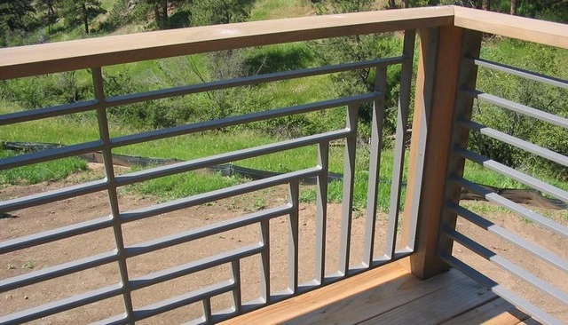 A creative railing design with horizontal and vertical metal slats intersecting at different heights, creating a modern stair step pattern that enhances visual interest.