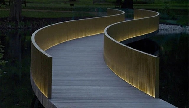 An elegant minimalist lighted slats handrail featuring an artistic design with ambient illumination, providing subtle sophistication to outdoor spaces.