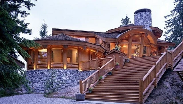 A grand log rustic stairs railing with 6-inch posts connected by mortise and tenon joints, showcasing traditional craftsmanship and sturdy design in innovative deck railing solutions.