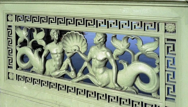 A decorative design showcasing mythical creatures adorning the Schlossbrücke Bridge near Berlin's historic palace, adding a whimsical touch to the architectural landscape.