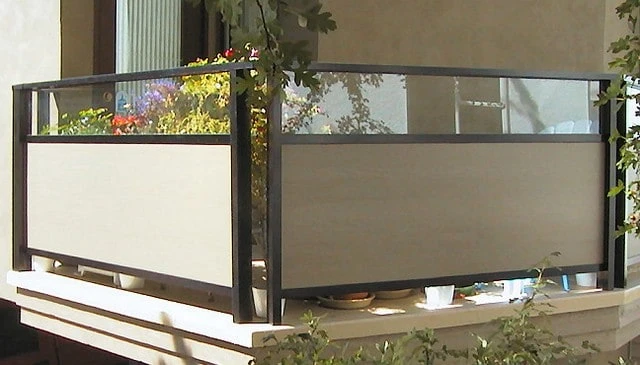 A metal frame railing design featuring solid Hardie panel sections topped with glass and framed in square black metal pipe, showcasing innovative deck railing designs.