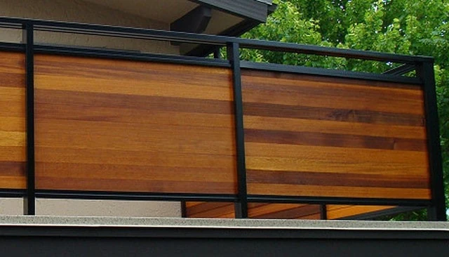 A craftsman-inspired railing design with a square black metal frame and a continuous top above solid horizontal cedar 1x4 boards, showcasing innovative deck railing designs.