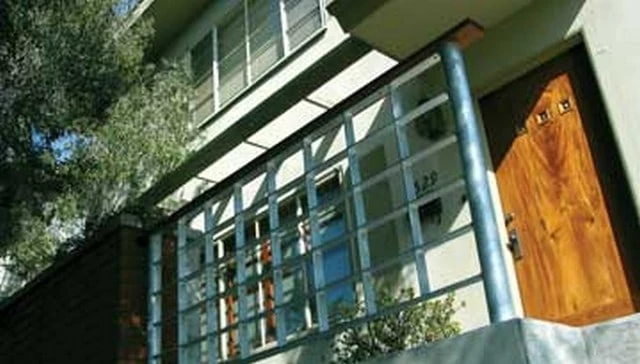 A grid pattern railing design featuring rectangular metal slats that enhance the material profile and aesthetic appeal in modern deck railing designs.