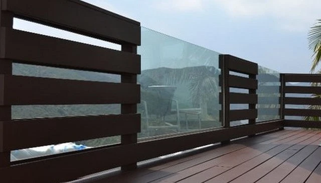 A railing design featuring horizontal 1x6 boards and glass panels, creating a spaced design that offers undulating views of the mountains beyond in innovative deck railing designs.