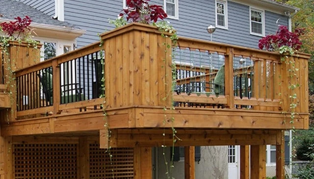 Glass baluster sections designed for unobstructed views, featuring wood corner posts transitioning to sleek metal baluster sections in innovative deck railing designs.