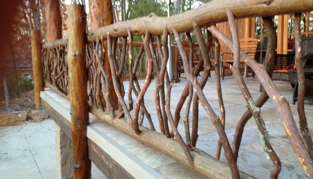 A rustic log framed porch featuring 6-inch locust logs and deck railing designs made from Mountain Laurel branch railings, perfect for scenic outdoor relaxation.